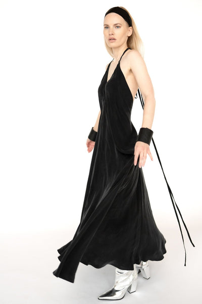 "Atvērts muguras dizains melnā Cupro zīda kleitā, kas piešķir elegantumu un vieglumu kustībām. Open back design on the black Cupro silk dress, adding elegance and fluidity to your movements."